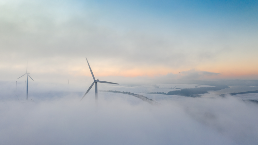 wind power turbines in clouds at sunset